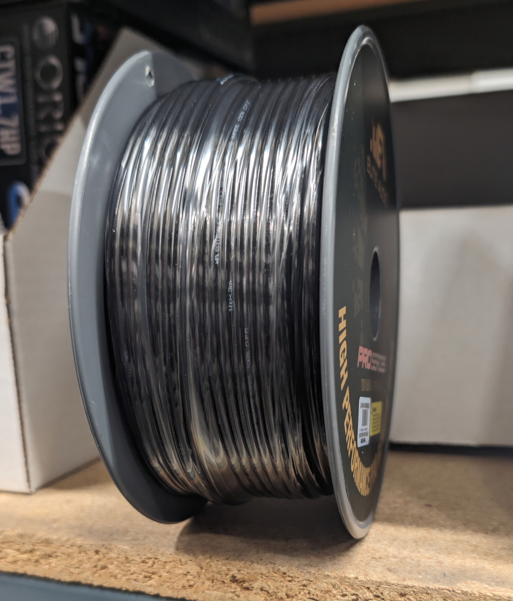 Elite Audio Remote Wire 16GA spool, side angled view showing wound black wire on shelf